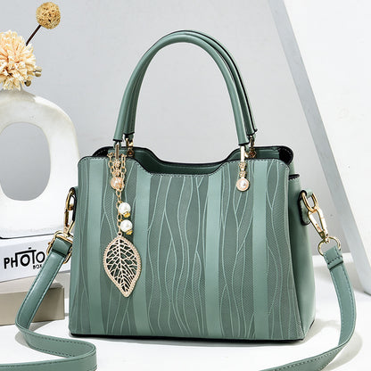 2026 new women's handbag wholesale: fashionable leaf charm, solid color, large capacity, minimalist shoulder bag, stylish tote, crossbody bag