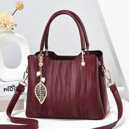 2026 new women's handbag wholesale: fashionable leaf charm, solid color, large capacity, minimalist shoulder bag, stylish tote, crossbody bag