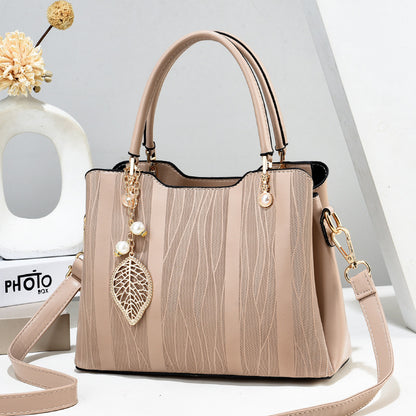 2026 new women's handbag wholesale: fashionable leaf charm, solid color, large capacity, minimalist shoulder bag, stylish tote, crossbody bag