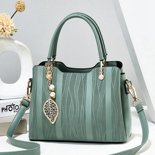 2026 new women's handbag wholesale: fashionable leaf charm, solid color, large capacity, minimalist shoulder bag, stylish tote, crossbody bag